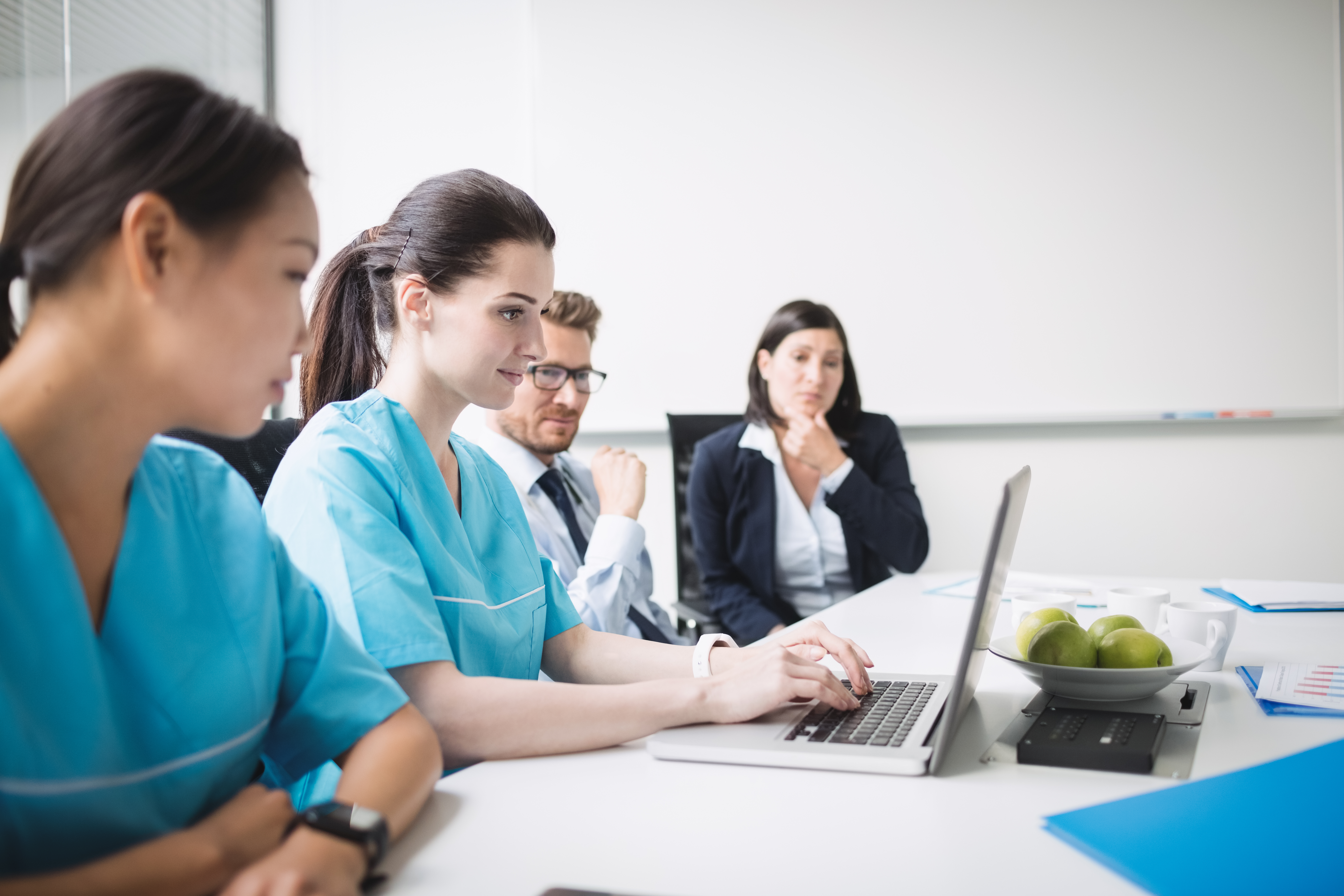 Nurse anesthesia student studying in a clinical setting, preparing for CRNA board certification